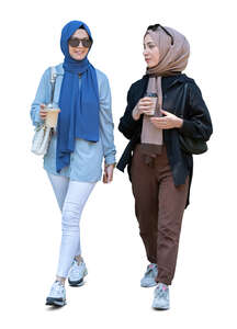 two cut out young muslim women walking and drinking coffee