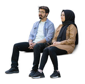 cut out middle eastern man and woman sitting