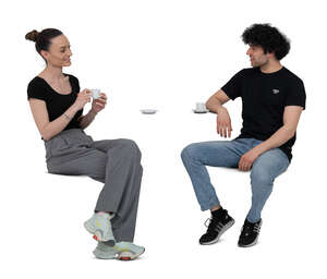 two cut out people sitting in a cafe and drinking coffee