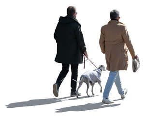 two cut out backlit men and a dog walking