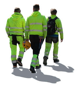 cut out group of backlit workmen walking