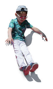 cut out boy sliding down on a slide on a playground