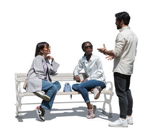 cut out man standing and talking to two women sitting