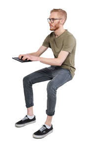 cut out man sitting and working with computer