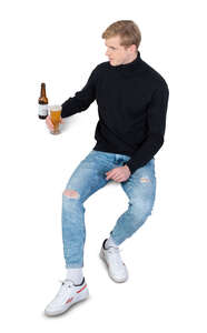 cut out man sitting and drinking beer seen from above