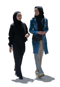 two cut out backlit muslim women walking