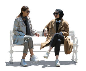 two cut out backlit muslim women sitting and talking
