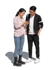 two cut out asian people standing and looking at a phone
