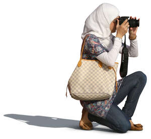 muslim woman kneeling while taking a picture