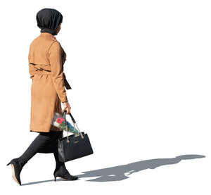 muslim woman with flowers in her bag walking