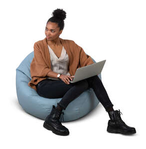 cut out woman sitting on a bean bag chair with a laptop