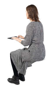 cut out woman sitting at a desk and working with a computer