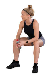 cut out woman at a gym taking a break and sitting
