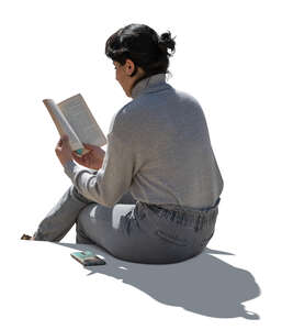 cut out backlit woman sitting and reading a book