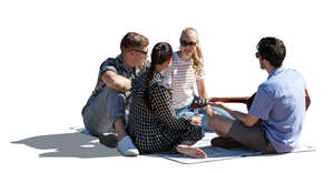 cut out backlit group of friends sitting in park and playing music