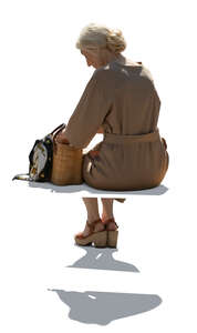 cut out backlit elderly woman in a beige dress sitting