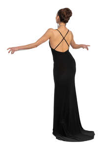 cut out woman in a long black dress standing on a balcony