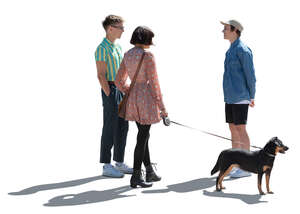 cut out backlit group of three young people with a dog standing