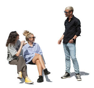 cut out man standing and talking to two women sitting on a bench