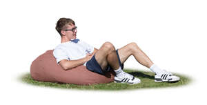 cut out young man sitting outside on a bean bag chair