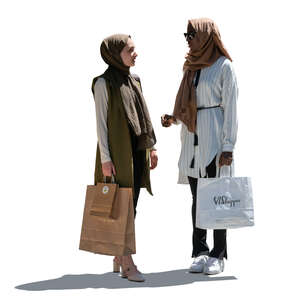 two cut out backlit muslim women standing