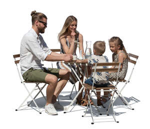 cut out family in a an outdoor restaurant sitting and eating