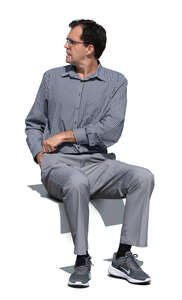 cut out man sitting outside and looking over his shoulder