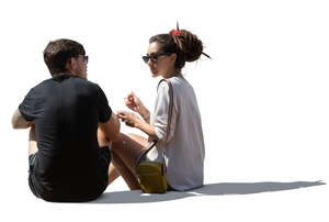 cut out young man and woman sitting and eating ice cream