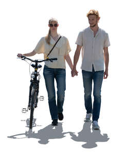 cut out backlit couple with a bike walking
