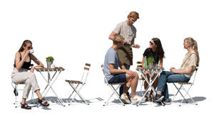cut out outdoor restaurant scene with people sitting and a waiter standing in summer