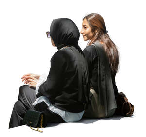 two cut out middle eastern women sitting in partial shade