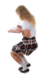 cut out schoolgirl sitting and writing