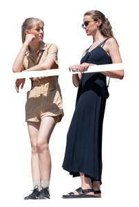 two cut out women standing on a balcony and talking