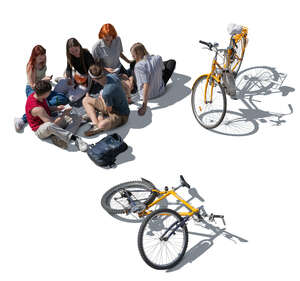 cut out group of young people with bikes sitting on the ground and having a picnic