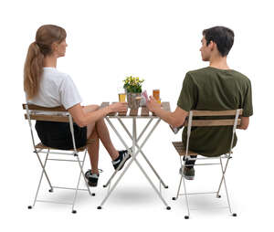 cut out man and woman sitting in a cafe seen from back angle