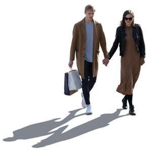 cut out backlit couple in autumn walking hand in hand