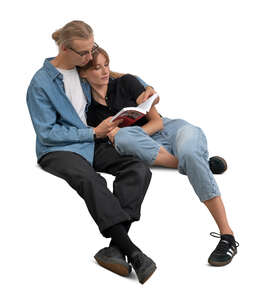 cut out couple cuddling on the sofa and reading a book