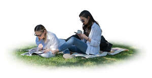 two cut out women relaxing in the park on the grass