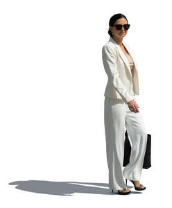 cut out woman in a white suit walking