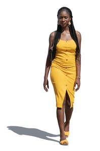cut out woman in a yellow summer dress walking