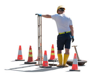 workman standing next to a manhole