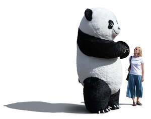 woman standing next to a giant panda