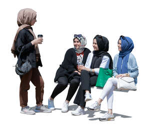 four muslim girls sitting and chatting