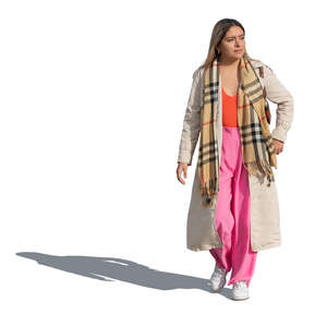 cut out mexican woman wearing a light fall coat walking