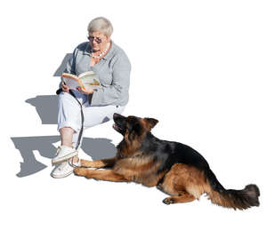 older woman with a german shepard dog sitting and reading seen from above