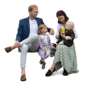 family with little kids sitting and having a snack