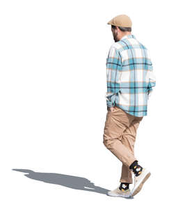 man with a checkered shirt and a hat walking