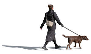 woman in autumn walking a dog