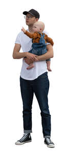 man holding a small child and looking up at smth