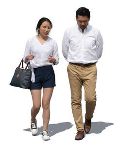 two asian people walking side by side